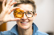 © magann - woman with glasses looking through orange glass