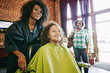 © Peathegee Inc/Blend Images - Smiling hairdresser and customers in hair salon