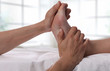 Woman enjoying foot massage. Acupressure. Therapist doing healing treatment treatment on female feel . Alternative medicine, pain relief concept