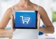 © vectorfusionart - Woman holding Tablet with Shopping trolley icon