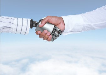 Poster - Android Robot hand shaking businessman hand with sky background