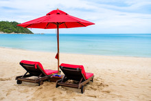 Red Beach Umbrella And Beach Chairs On A Beautiful Island