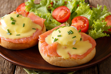 Eggs Benedict with salmon and hollandaise sauce close-up. horizontal