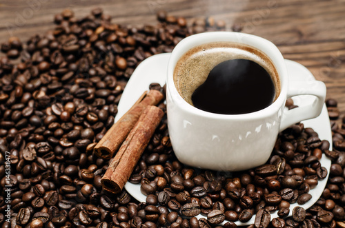 Fotografie, Obraz Coffee cup with beans and cinamon on a wooden table