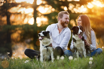 Wall Mural - Romantic happy couple in love enjoying their time with pets