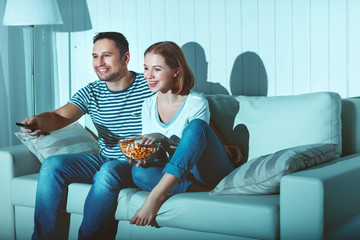 Wall Mural - Family couple watching television at home on sofa