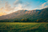 Fototapeta Na ścianę - Mountain landscape in Croatia at sunset. Fields and mountains in Croatia