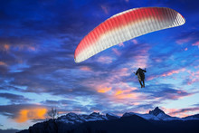 Paraglider Flying Over Mountains In Winter Sunset