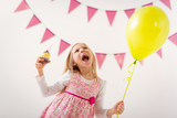 Little Girl With Balloon And Cupcake