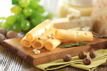 Poster - Wooden board with variety of cheese on table