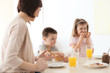 © Africa Studio - Mother and children having breakfast at home