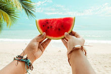 Relaxation And Leisure In Summer - Lifestyle Image Of Tanned Woman Holding A Watermelon, On Hands Many Seashell Bracelets. Tropical Island Beach. Summer Vacation Concept. Vintage Color Tone.