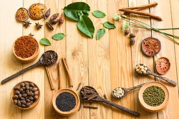 Wall Mural - Herbs and spices on a wooden board