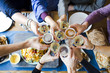 © Jordi Huisman - group of friends toasting with beers and wine over dinner