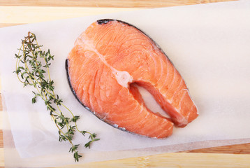 fresh raw salmon with spices on wooden cutting board. ready for cookin