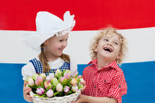Dutch Kids With Tulip Flowers And Netherlands Flag