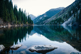 Fototapeta Góry - Majestic blue mountain lake with green trees