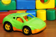 Car toy on the background of colored cubes