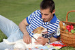© dream@do - Happy smiling man resting at a picnic in park with a dog Jack russell terrier. Lunch break outdoors , Time for relax, Leisure Lifestyle Concept