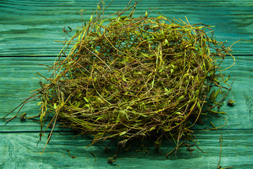 The nest of hay, a bunch of dry grass on a wood background