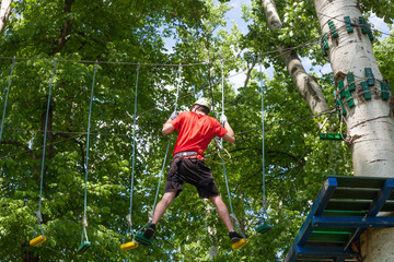 man in adventure park on  tree top