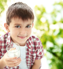 Wall Mural - Cute boy drinking water on kitchen