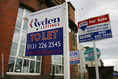 Property For Sale And To Let Signs Are Seen Outside A Block Of
