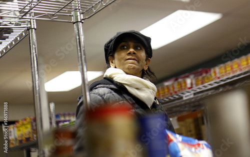 Woman Looks At Groceries At Community Kitchen Food Bank For New