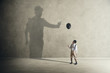 man and shadow with black balloon