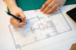 Architect working on blueprints on her table. Architecture and construction. Color pallete