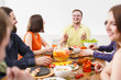 © Prostock-studio - Group of happy people at festive table dinner party