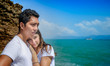 © schamin - A mixed race couple - Thai man and European woman - at a cliff, watching waves making splashes