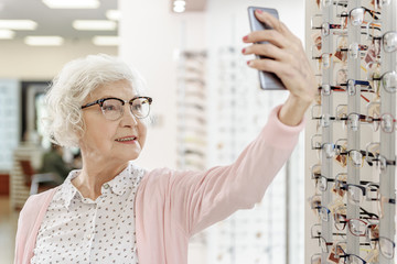 Stylish senior woman in optic shop