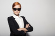 © yuriyzhuravov - Fashion portrait of serious woman dressed as a secret agent or spy. Gray background.