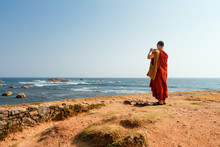 A Buddhist Monk At Fort Halle In Sri Lanka Takes Pictures Of The Ocean.