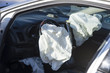 Deployed airbag, wrecked car