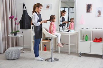 Wall Mural - Cute little girl in hairdressing salon