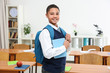 © Africa Studio - Cute boy with backpack and book standing in classroom