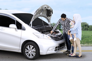 Wall Mural - Muslim family checking a broken car