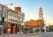 Main street of rural small town in midwest USA with storefronts and clock tower