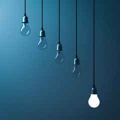 Aufkleber - One hanging light bulb glowing different and standing out from unlit incandescent bulbs with reflection on dark cyan background , leadership and different business creative idea concept. 3D rendering.