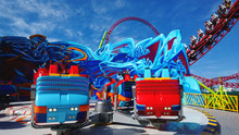 Bright Booths On One Of The Rides In The Amusement Park. Roller Coaster In The Background