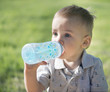 © Vitaly Krivosheev - The kid drinks water from a bottle