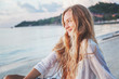 © olezzo - Portrait of an attractive young woman with long hair on the sea shore