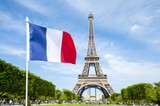 Fototapeta Tęcza - French flag flying in bright blue sky above the Eiffel Tower in Paris, France