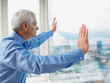 © Connect Images - Business Man looking through window