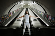 Olympic Competitor Standing At Bottom Of Escalators