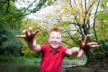 Boy Pretending To Be A Monster In A Woodland