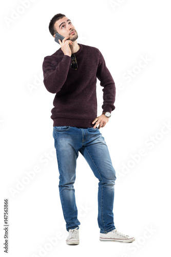 Bored Young Casual Man Listening On The Phone Looking Up Full Body Length Portrait Isolated Over White Studio Background Buy This Stock Photo And Explore Similar Images At Adobe Stock