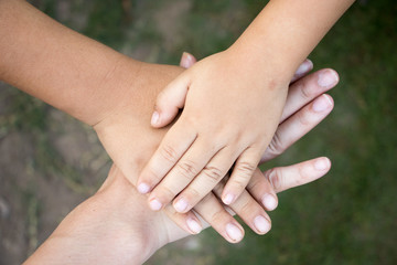 Wall Mural - Background of hands of asian female adult and two kids group together for support